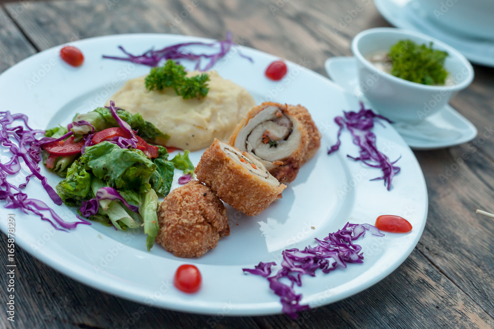 Baked chicken rolls with vegetable salad and mashed potato Baked chicken rolls with vegetable salad and mashed potato