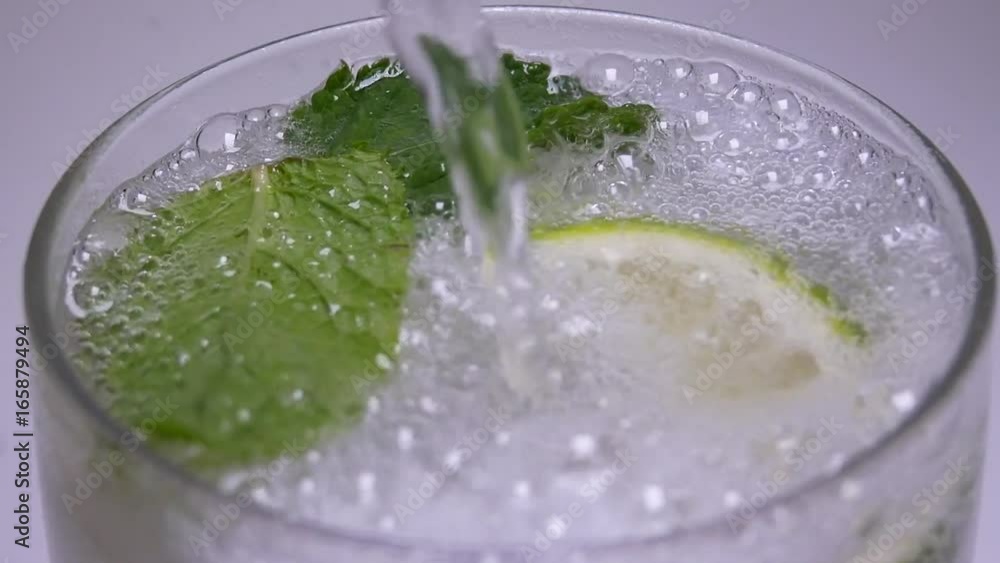 Soda Pop Derives From Bottle Down In Glass With Leaves of Mint and
