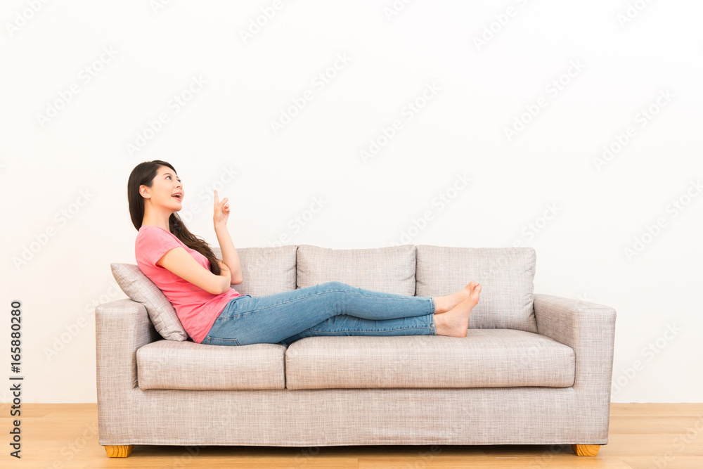 young woman leisurely sitting on the couch sofa