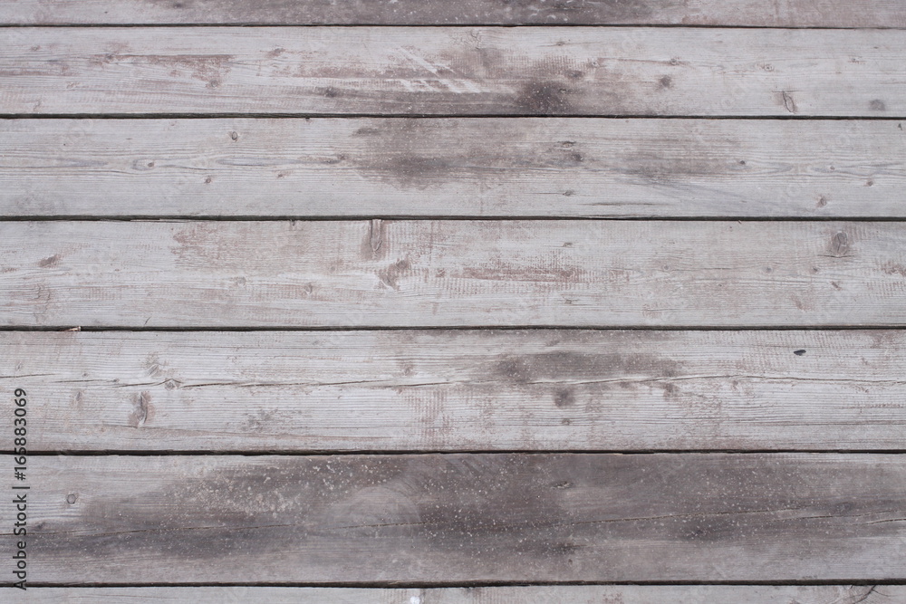 Naklejka premium The surface of the old darkened wood. The boards of the bridge over the lake.