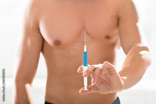 Shirtless Bodybuilder Man Holding Syringe In Hand