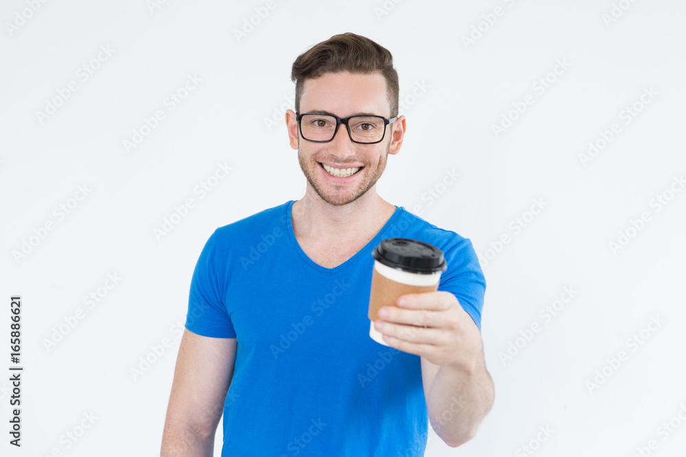 Cheerful energetic young man with take-out coffee