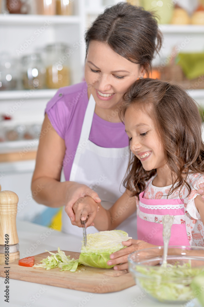 Mother and daughter preparing dinner