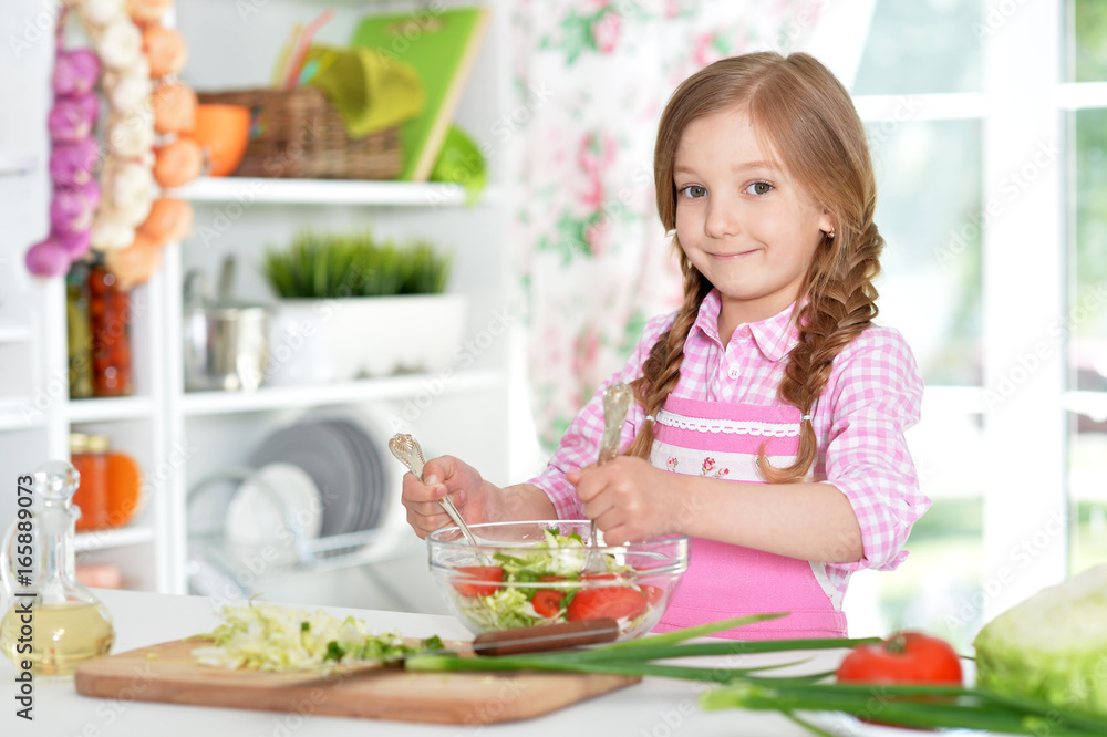 little girl preparing vegetable salad little girl preparing vegetable salad