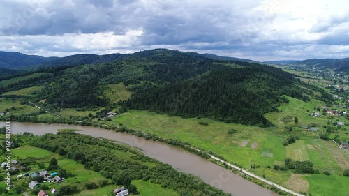aerial view agriculture field and mountains. summer day. Summer day landscape.  Flying over the beautiful rural landscape. Aerial camera shot. 