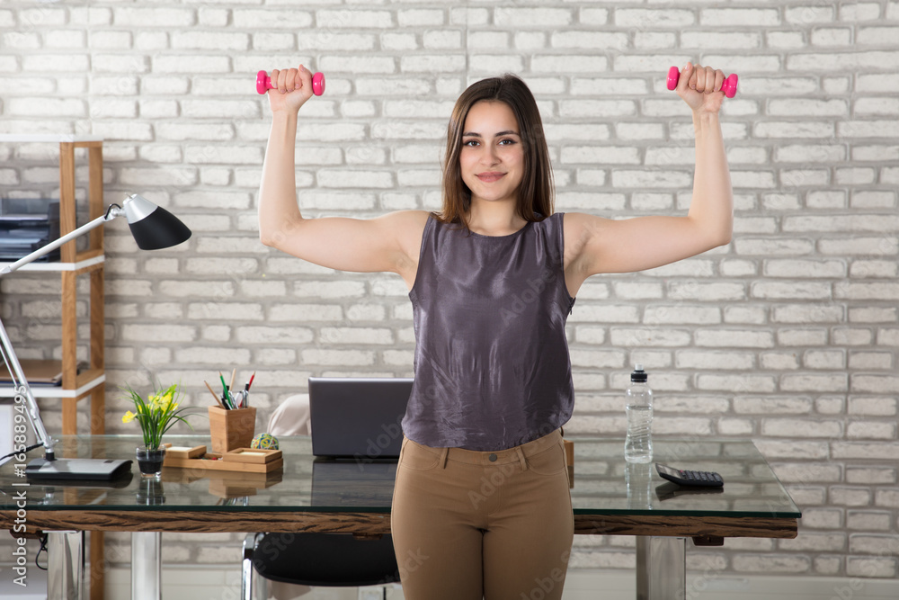 Businesswoman Doing Exercise In Office Businesswoman Doing Exercise In Office