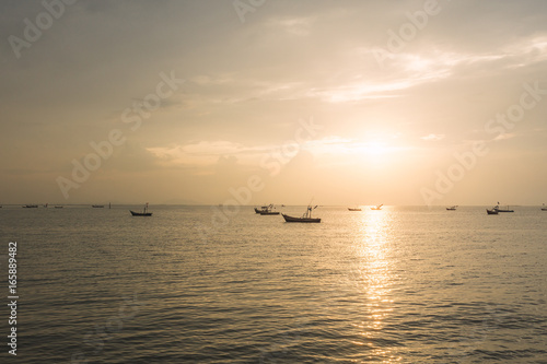 boats with a beautiful sunset at the sea © abzolutewin