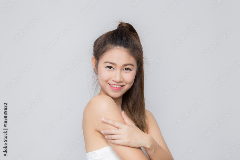 Asian beautiful women smiling and touching her arm Asian beautiful women smiling and touching her arm