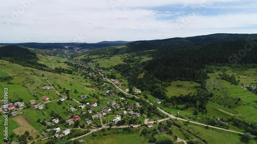 aerial view agriculture field and mountains. summer day. Summer day landscape.  Flying over the beautiful rural landscape. Aerial camera shot. 