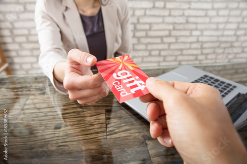 Colleague Gives Gift Card To Businesswoman photo