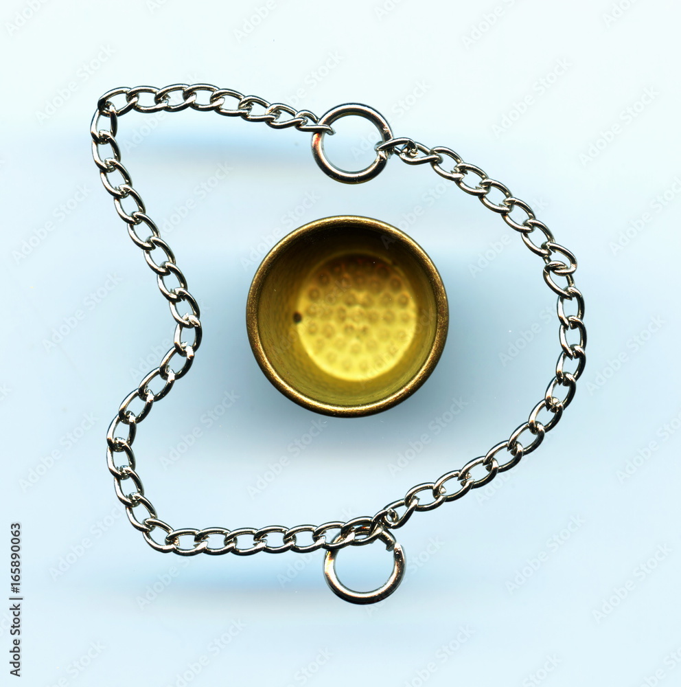 Small chain and brass thimble Small chain and brass thimble