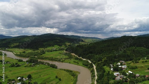 aerial view agriculture field and mountains. summer day. Summer day landscape.  Flying over the beautiful rural landscape. Aerial camera shot. 
