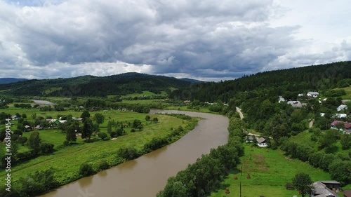 aerial view agriculture field and mountains. summer day. Summer day landscape.  Flying over the beautiful rural landscape. Aerial camera shot. 
