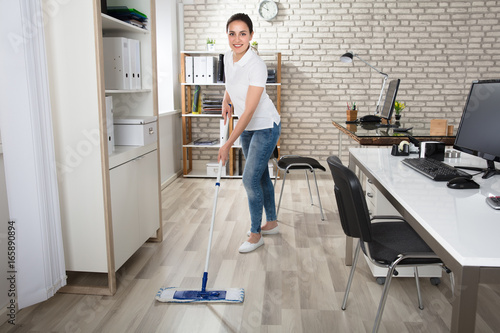 Young Woman Cleaning The Floor