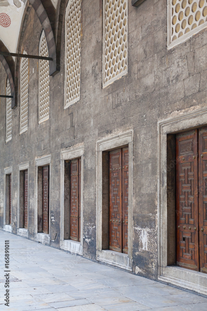 Portico with doors in a row in the courtyard of an ancient mosque Portico with doors in a row in the courtyard of an ancient mosque