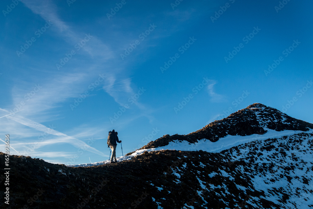 Man hiking a snowy mountain