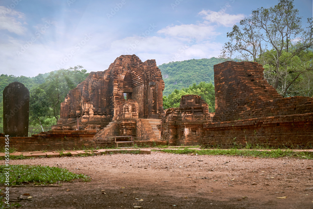 Old religious buildings from the Champa empire - cham culture. In my son, near Hoi an, Vietnam. World heritage site. Sun breaking through the clouds.