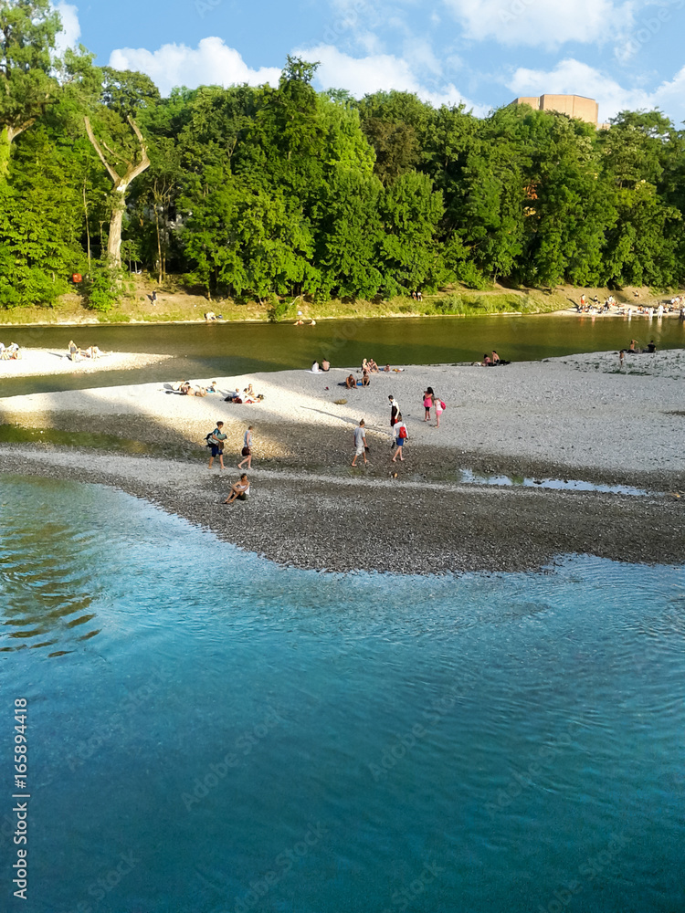 People relaxing by the Isar river in Munich (Bavaria, Germany)