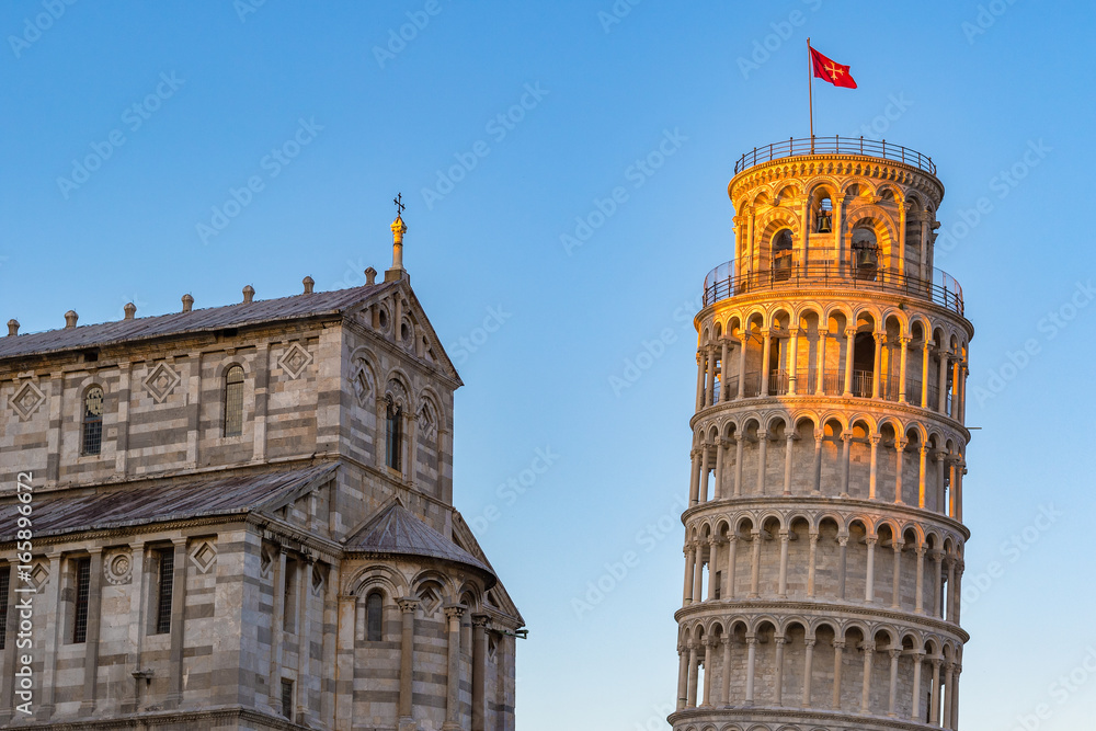 Golden sunlight hit on the top of the Leaning Tower and Pisa Cathedral in Italy