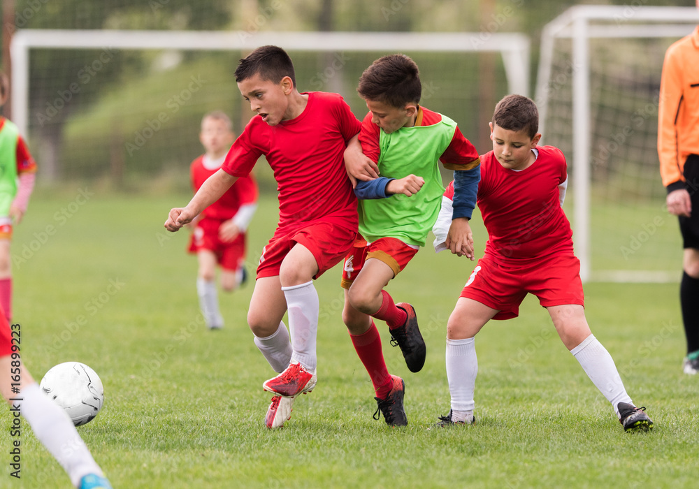 Kids soccer football - children players match on soccer field