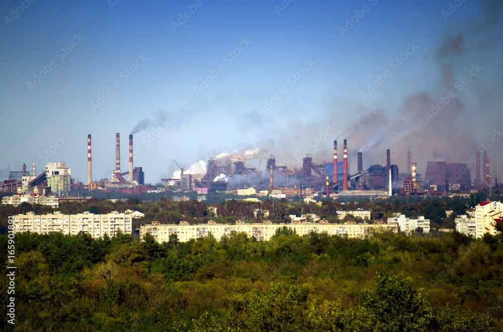 Pipes with smoke, urban landscape in summer
