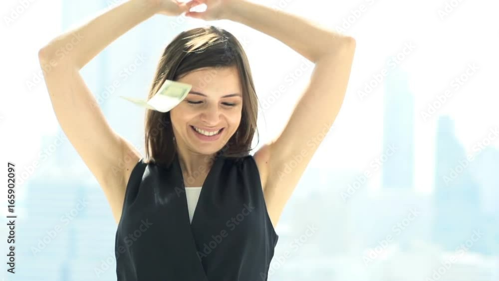 Happy, rich woman throwing money standing by window at home
Happy, rich woman throwing money standing by window at home