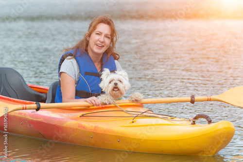 Woman and her dog on a kayak