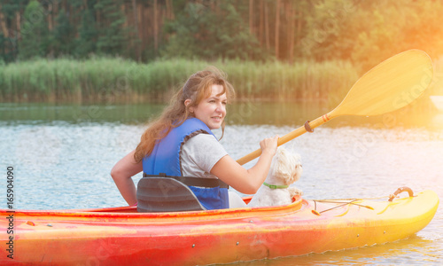 Woman and her dog on a kayak