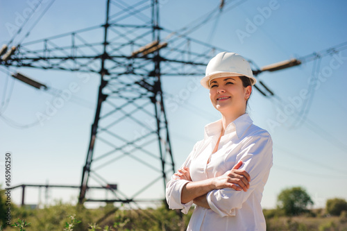 beautiful woman engineer work at an electrical substation.