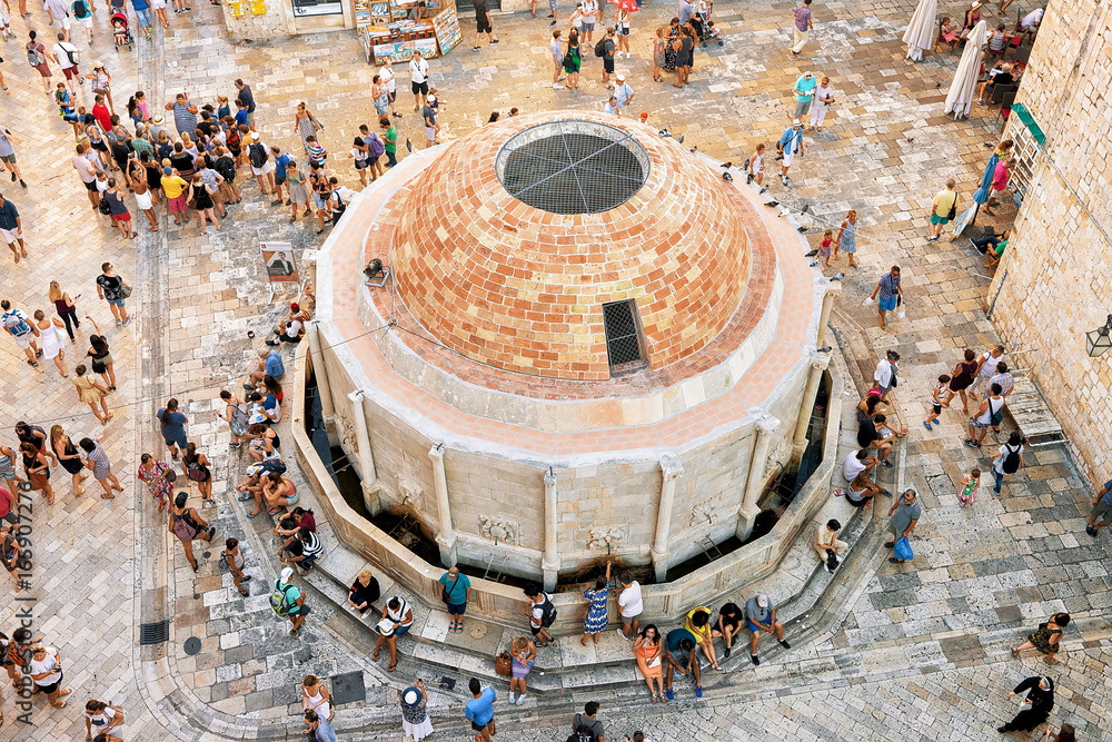 People at Large Onofrio Fountain in Old city of Dubrovnik