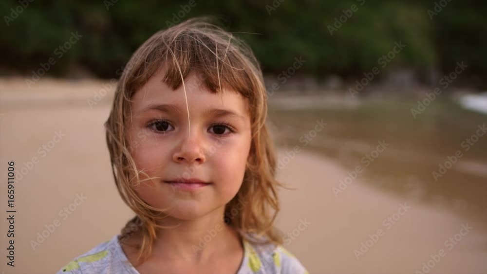 Portrait of a cute little brown-eyed girl on the seashore Portrait of a cute little brown-eyed girl on the seashore