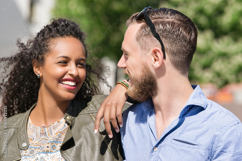 Young multiracial couple looking at each other tenderly Young multiracial couple looking at each other tenderly