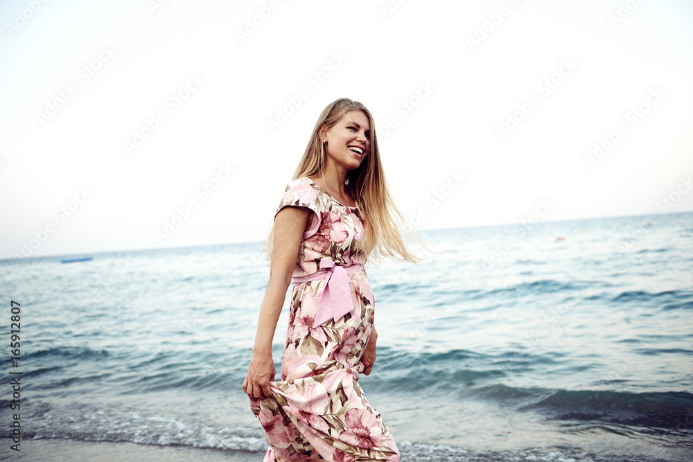 Happy smiling pregnant woman over blue sea landscape background. Concept of happiness and carefree. Happy smiling pregnant woman over blue sea landscape background. Concept of happiness and carefree.