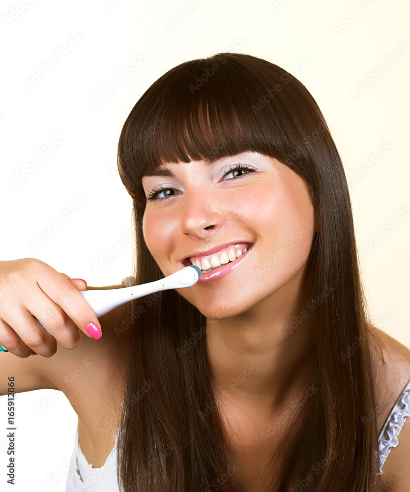 smiling woman with great white teeth holding a toothbrush smiling woman with great white teeth holding a toothbrush