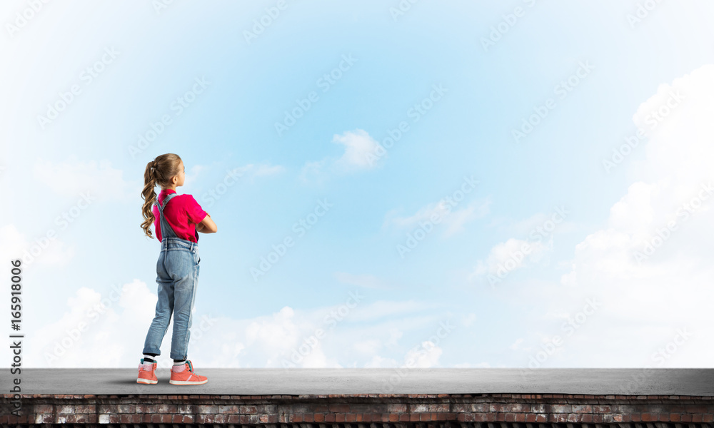Concept of careless happy childhood with girl looking far away Concept of careless happy childhood with girl looking far away