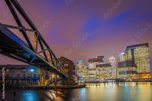 Fototapeta Naklejka Na Ścianę i Meble -  London, England - Colorful night sky at Canary Wharf financial district with skyscapers and residential buildings at the docklands of London by night