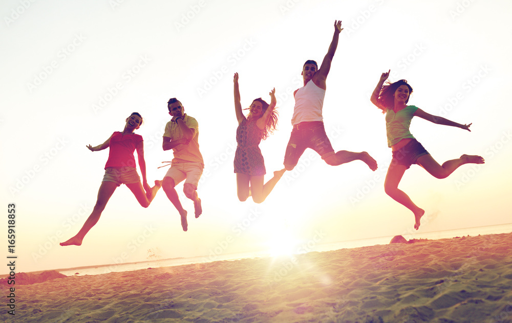 smiling friends dancing and jumping on beach smiling friends dancing and jumping on beach