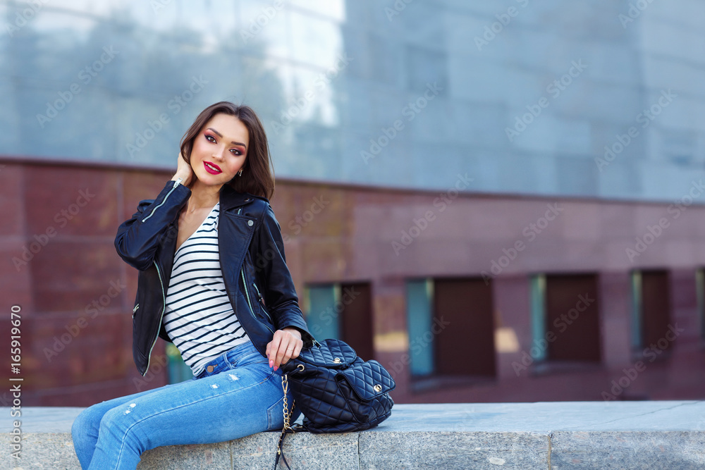 Fototapeta premium Young woman posing in black jacket. Fashion makeup