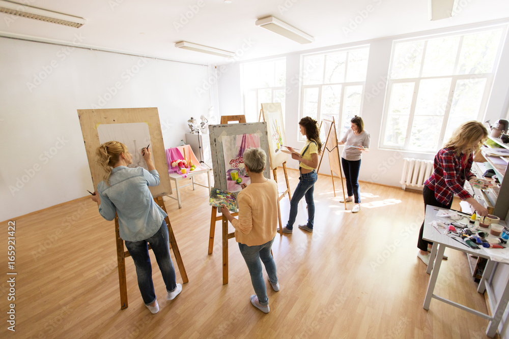 woman artists with brushes painting at art school woman artists with brushes painting at art school