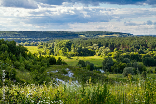 Summertime landscape - river valley of the Siverskyi (Seversky) Donets, the winding river over the meadows between hills and forests, border region of Ukraine near to Russia © rustamank