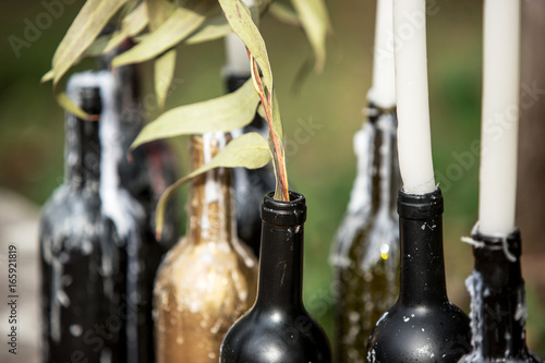 Burning candle in the vintage black bottle photo