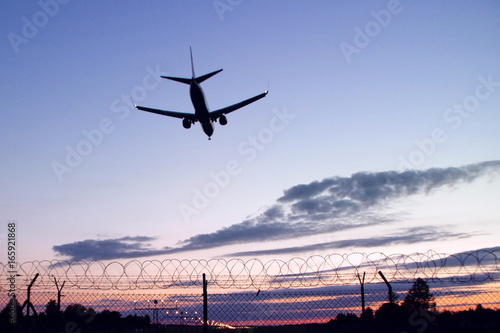 Silhouette of aircraft landing
