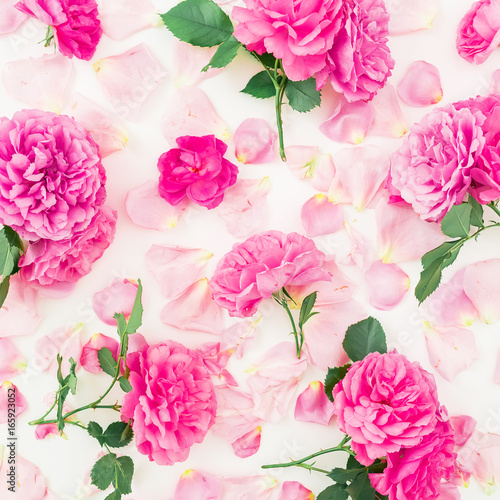 Floral pattern made of pink roses and petals on white background. Flat lay, top view