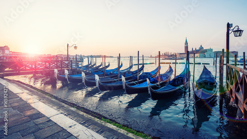 Gondolas at sunrise with Chiesa di San Giorgio Maggiore in background in Venice, Italy