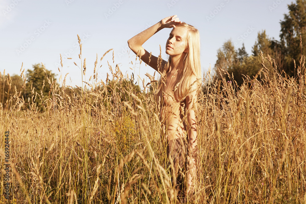 Fototapeta premium woman on field with clothes off