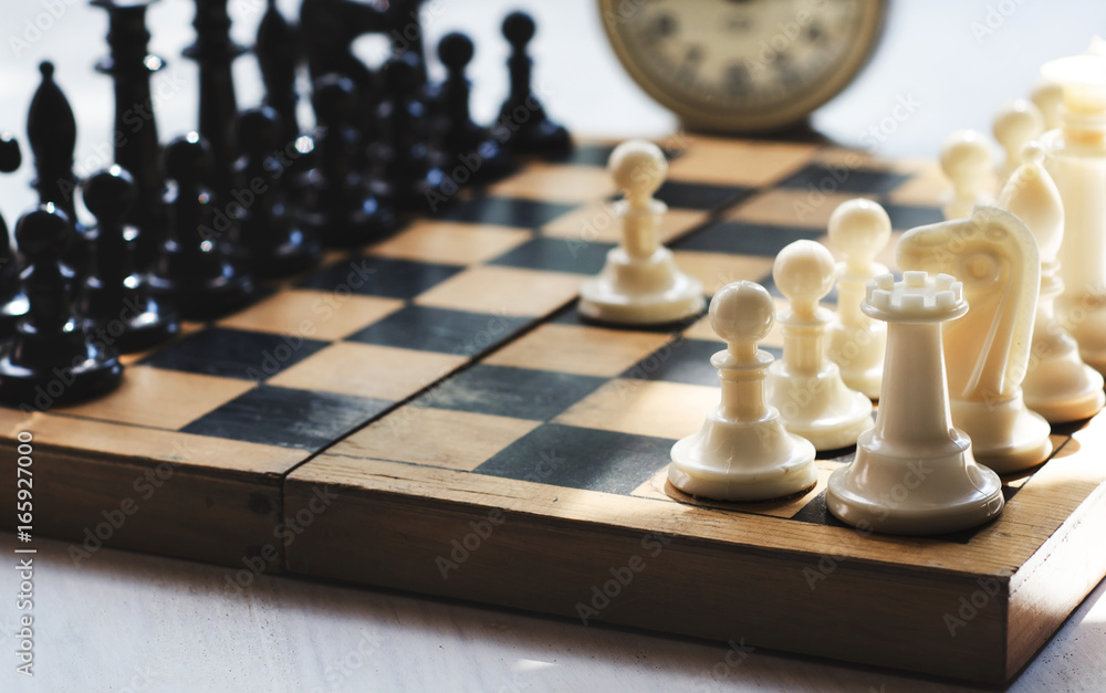 White and black pieces on chess board White and black pieces on chess board