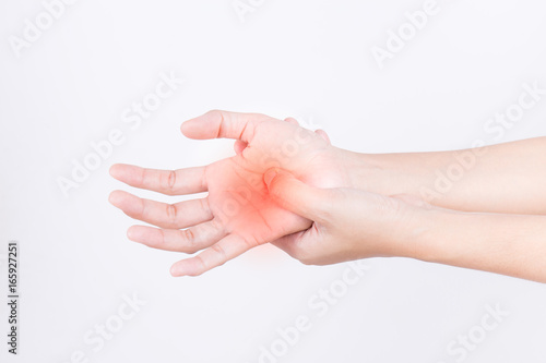 The hands of the girl with pain,Carpal Tunnel Syndrome from work,hand pain highlighted by red dots on white background