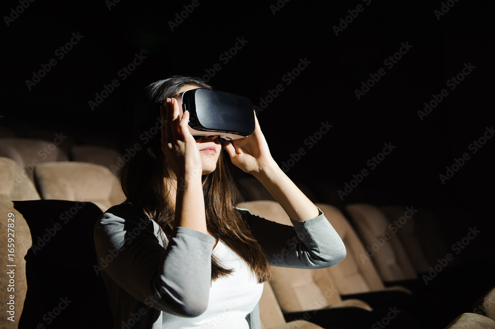Young woman experiencing virtual reality glasses Young woman experiencing virtual reality glasses