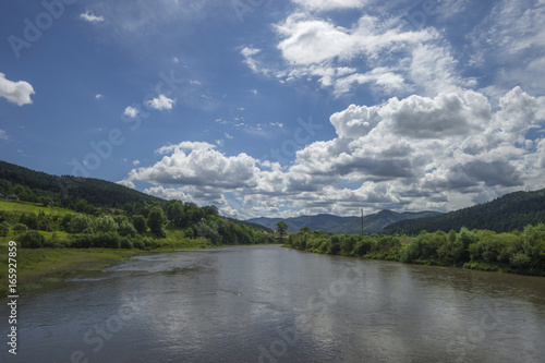 summer day landscape river, mountains, cloudy sky
