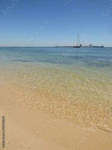 Beach landscape with transparent waters at Natural Park of Arrabida in Setubal, Portugal - Troia Peninsula in the background